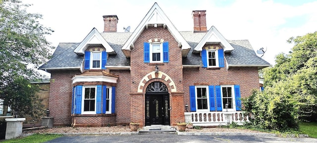 12 Monell Pl, Beacon, NY 12508 - view of front facade with a chimney, brick siding, and a shingled roof