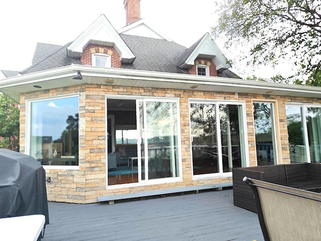 12 Monell Pl, Beacon, NY 12508 - back of house featuring a deck, stone siding, and roof with shingles