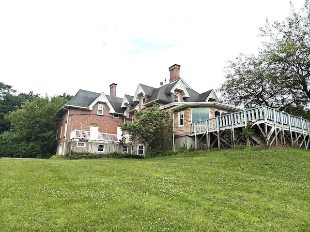 12 Monell Pl, Beacon, NY 12508 - rear view of property with a chimney, a yard, and brick siding