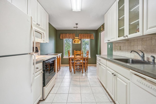 914 Fenway Rd, Saint James, NY 11780 - kitchen with white appliances, decorative backsplash, light tile patterned flooring, and white cabinets