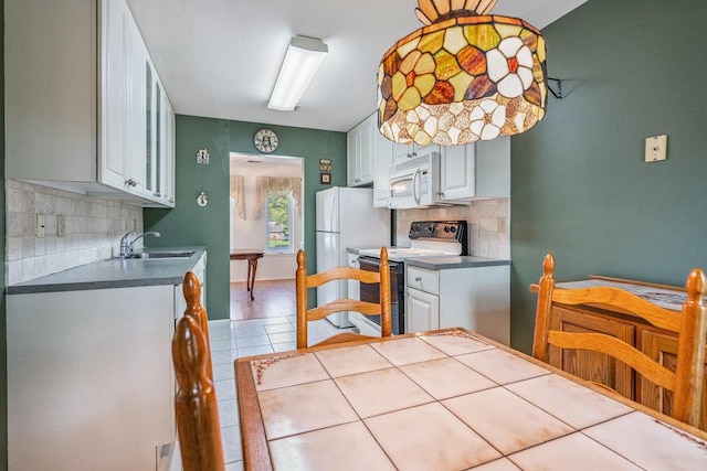 914 Fenway Rd, Saint James, NY 11780 - kitchen featuring white appliances, white cabinetry, backsplash, and dark countertops