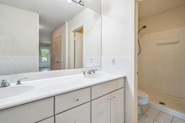914 Fenway Rd, Saint James, NY 11780 - bathroom with tile walls, tile patterned floors, a stall shower, double vanity, and a wainscoted wall