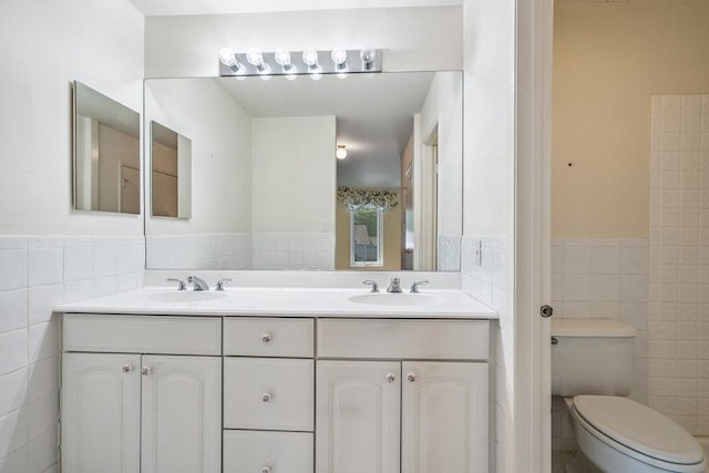 914 Fenway Rd, Saint James, NY 11780 - full bathroom featuring tile walls, double vanity, and a wainscoted wall