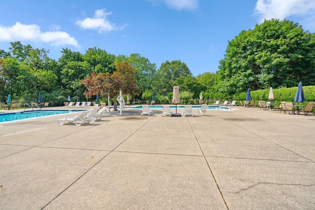914 Fenway Rd, Saint James, NY 11780 - community pool featuring a patio and view of wooded area