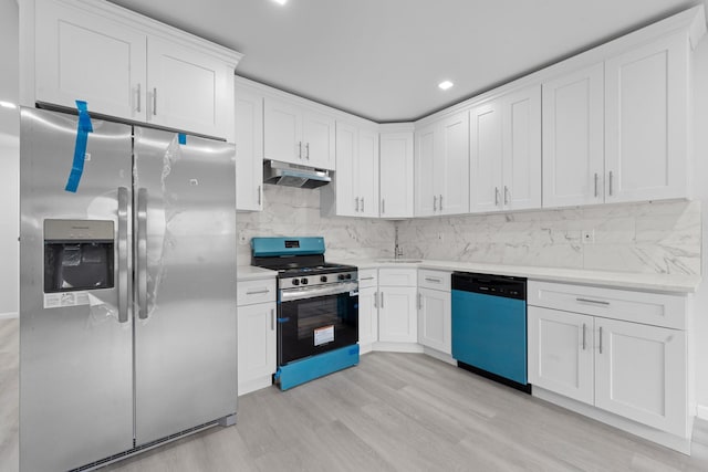 19432 113th Rd, Hollis, NY 11412 - kitchen with appliances with stainless steel finishes, light countertops, backsplash, light wood finished floors, and white cabinetry