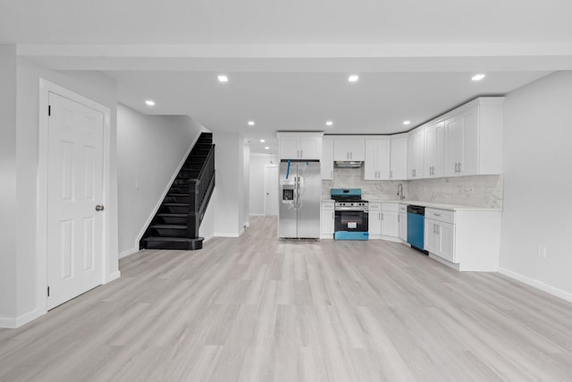 19432 113th Rd, Hollis, NY 11412 - kitchen featuring appliances with stainless steel finishes, under cabinet range hood, light wood-style flooring, backsplash, and recessed lighting