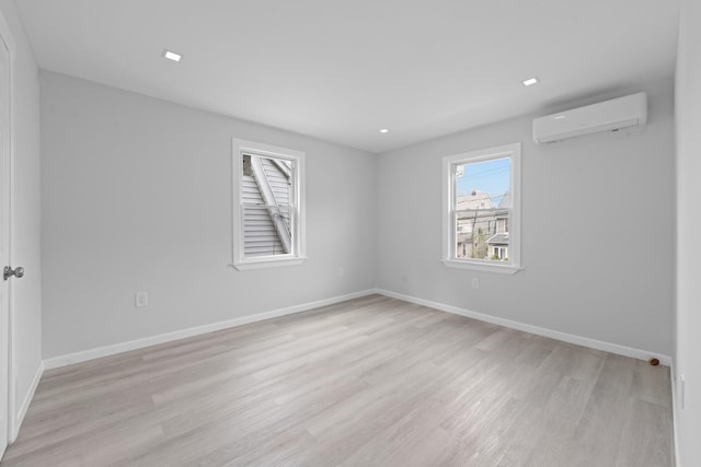 19432 113th Rd, Hollis, NY 11412 - spare room with a wall mounted AC and light wood finished floors