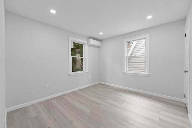 19432 113th Rd, Hollis, NY 11412 - empty room with a wall unit AC, light wood-type flooring, and recessed lighting