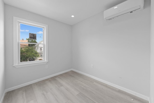 19432 113th Rd, Hollis, NY 11412 - spare room featuring an AC wall unit and light wood-type flooring