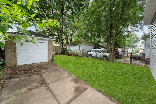 19432 113th Rd, Hollis, NY 11412 - view of yard with concrete driveway, an outbuilding, and a detached garage