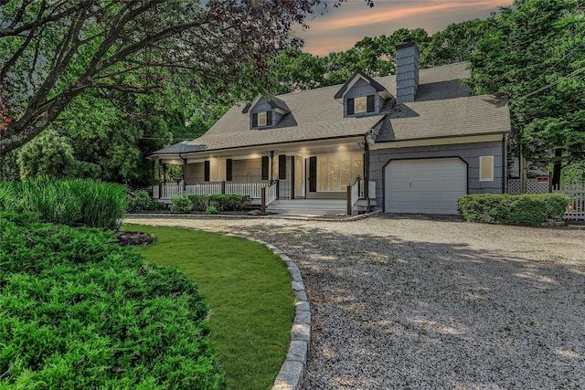 31 Neptune Ave, Mastic, NY 11950 - cape cod-style house featuring covered porch, gravel driveway, a chimney, an attached garage, and roof with shingles