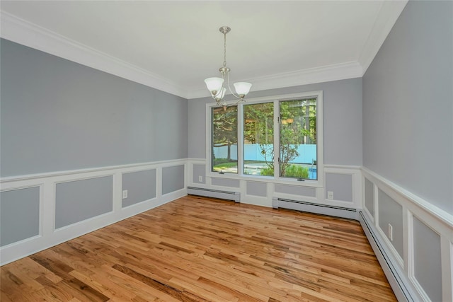 31 Neptune Ave, Mastic, NY 11950 - unfurnished dining area with baseboard heating, a chandelier, ornamental molding, wainscoting, and wood finished floors