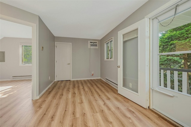 31 Neptune Ave, Mastic, NY 11950 - unfurnished room featuring a wall mounted air conditioner, baseboard heating, and light wood-style floors