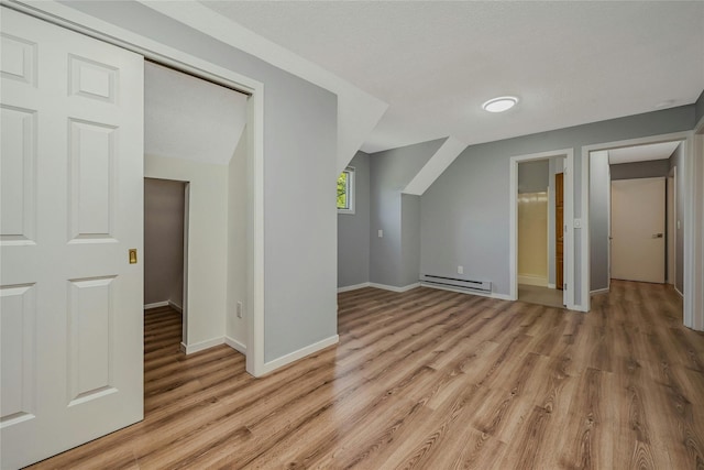 31 Neptune Ave, Mastic, NY 11950 - additional living space with baseboard heating and light wood-type flooring