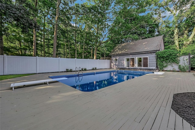 31 Neptune Ave, Mastic, NY 11950 - view of swimming pool with a deck, a fenced backyard, an outdoor structure, and a diving board