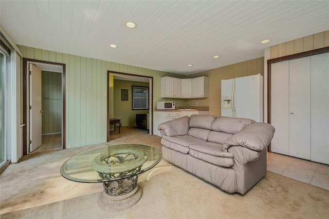 31 Neptune Ave, Mastic, NY 11950 - living room featuring light carpet, recessed lighting, light tile patterned floors, and wood walls