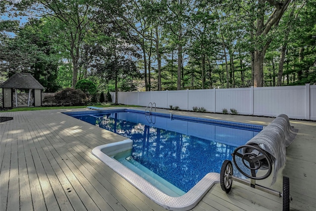 31 Neptune Ave, Mastic, NY 11950 - view of swimming pool with a fenced backyard, a deck, a gazebo, and view of scattered trees