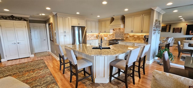 12 Omni Parc Dr, Nanuet, NY 10954 - kitchen featuring stainless steel appliances, custom exhaust hood, cream cabinetry, a kitchen bar, and crown molding