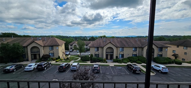 12 Omni Parc Dr, Nanuet, NY 10954 - view of building exterior with uncovered parking and a residential view
