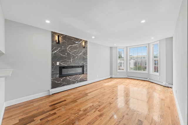 1070 Kelly St, Bronx, NY 10459 - unfurnished living room with a premium fireplace, wood finished floors, recessed lighting, and a wall mounted air conditioner