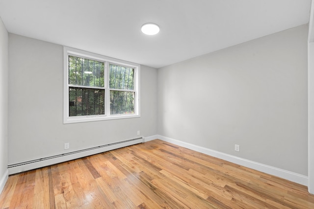 1070 Kelly St, Bronx, NY 10459 - unfurnished room featuring baseboard heating and wood finished floors