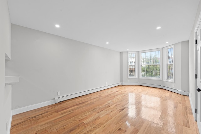 1070 Kelly St, Bronx, NY 10459 - empty room featuring baseboard heating, wood finished floors, and recessed lighting