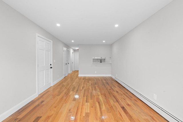1070 Kelly St, Bronx, NY 10459 - unfurnished living room featuring a baseboard radiator, light wood finished floors, and recessed lighting