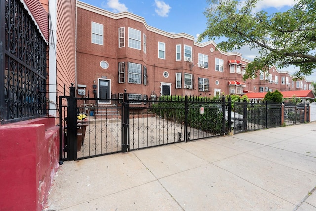 1070 Kelly St, Bronx, NY 10459 - view of front of home featuring a gate, a fenced front yard, and brick siding