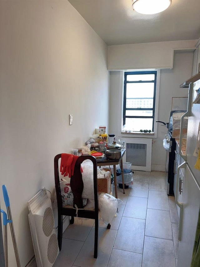 14450 38th Ave Unit B5, Flushing, NY 11354 - dining room with light tile patterned flooring and radiator
