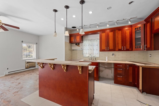 11501 Linden Blvd, South Ozone Park, NY 11420 - kitchen featuring a baseboard radiator, dark brown cabinets, a ceiling fan, backsplash, and a kitchen breakfast bar