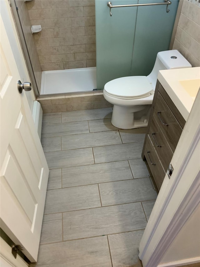 6 2nd Pl, Roosevelt, NY 11575 - bathroom with vanity, a shower stall, and wood tiled floors