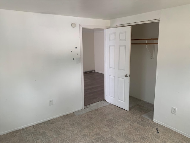 6 2nd Pl, Roosevelt, NY 11575 - unfurnished bedroom with baseboards and a closet