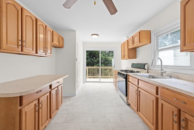 690 Corbalis Pl, Yonkers, NY 10703 - kitchen with gas range, healthy amount of natural light, light countertops, and a ceiling fan