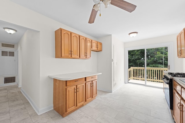 690 Corbalis Pl, Yonkers, NY 10703 - kitchen with black gas range, light countertops, and ceiling fan