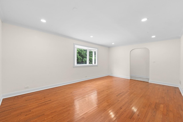 690 Corbalis Pl, Yonkers, NY 10703 - empty room featuring crown molding, light wood-type flooring, recessed lighting, and arched walkways
