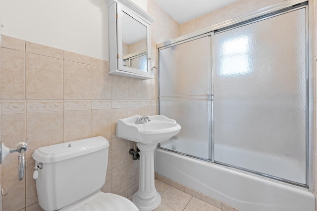 690 Corbalis Pl, Yonkers, NY 10703 - bathroom with tile walls, combined bath / shower with glass door, and tile patterned floors