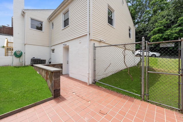 690 Corbalis Pl, Yonkers, NY 10703 - view of side of property featuring a gate, stucco siding, and a chimney