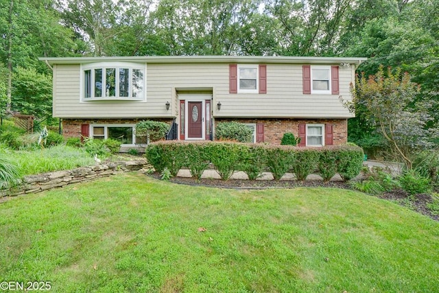 193 Washington Ave, Tappan, NY 10983 - bi-level home featuring a front lawn and brick siding