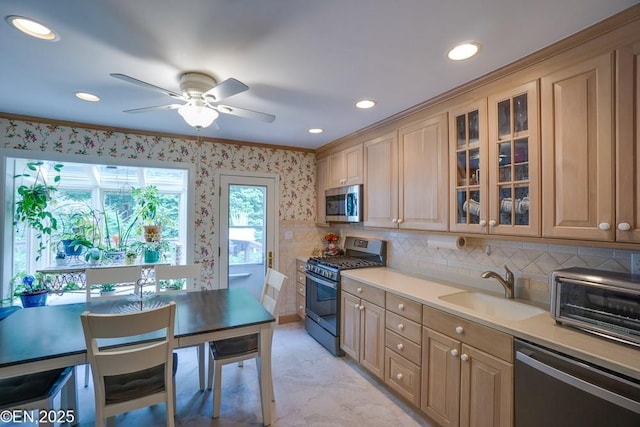 193 Washington Ave, Tappan, NY 10983 - kitchen featuring appliances with stainless steel finishes, ceiling fan, ornamental molding, glass insert cabinets, and light countertops