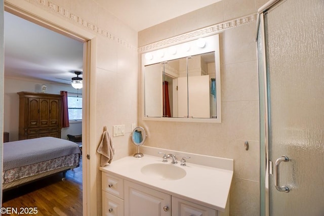 193 Washington Ave, Tappan, NY 10983 - ensuite bathroom featuring vanity, a stall shower, a ceiling fan, and wood finished floors