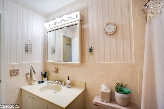 193 Washington Ave, Tappan, NY 10983 - bathroom with wallpapered walls, vanity, tile walls, and wainscoting