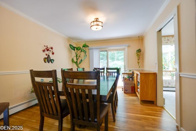 193 Washington Ave, Tappan, NY 10983 - dining space with a baseboard heating unit, light wood-style floors, and crown molding