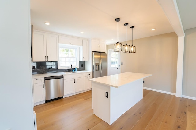 280 Neptune Ave, West Babylon, NY 11704 - kitchen featuring appliances with stainless steel finishes, light wood-style flooring, white cabinetry, light countertops, and recessed lighting