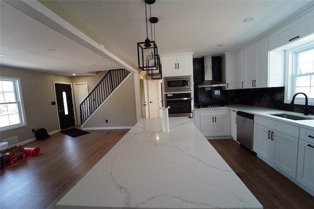 280 Neptune Ave, West Babylon, NY 11704 - kitchen with wall chimney exhaust hood, appliances with stainless steel finishes, decorative backsplash, dark wood-style floors, and recessed lighting