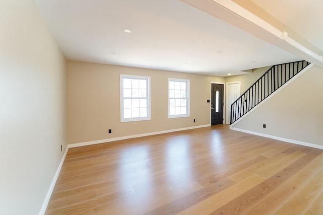 280 Neptune Ave, West Babylon, NY 11704 - unfurnished living room with stairway, light wood-type flooring, and recessed lighting