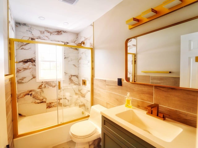 280 Neptune Ave, West Babylon, NY 11704 - bathroom featuring tile walls, vanity, and enclosed tub / shower combo