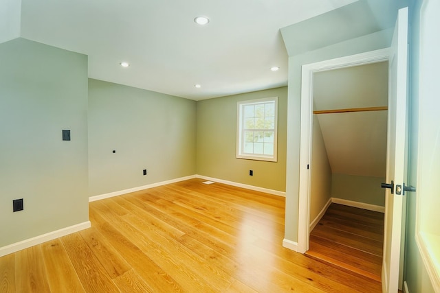 280 Neptune Ave, West Babylon, NY 11704 - unfurnished bedroom with a closet, light wood-style floors, and recessed lighting