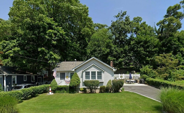 377 Locust Dr, Rocky Point, NY 11778 - view of front of home with a chimney and concrete driveway