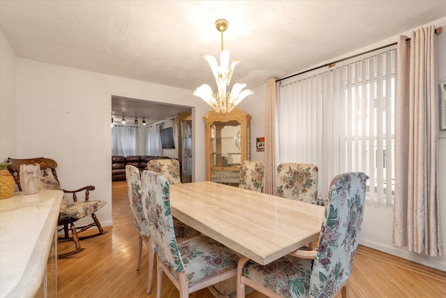 48 Carstairs Rd, Valley Stream, NY 11581 - dining space with a chandelier and light wood-type flooring