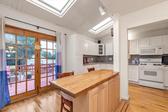 48 Carstairs Rd, Valley Stream, NY 11581 - kitchen with white appliances, a skylight, wooden counters, decorative backsplash, and white cabinetry